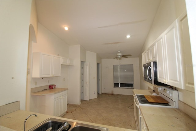 3803 Albacete Cir Unit 64, Punta Gorda, FL 33950 - kitchen with white electric range oven, stainless steel microwave, white cabinetry, ceiling fan, and a sink