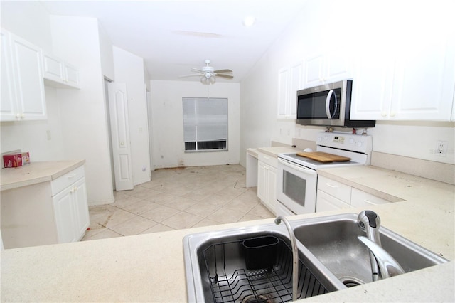 3803 Albacete Cir Unit 64, Punta Gorda, FL 33950 - kitchen with electric range, stainless steel microwave, a sink, and white cabinets