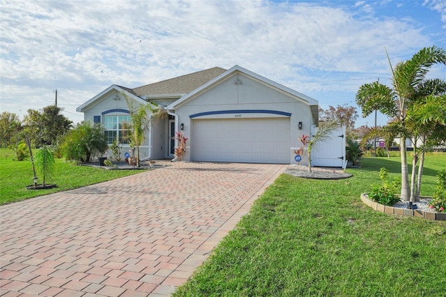 ranch-style home with decorative driveway, an attached garage, a front lawn, and stucco siding