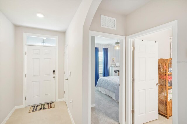 foyer entrance with baseboards and light tile patterned flooring