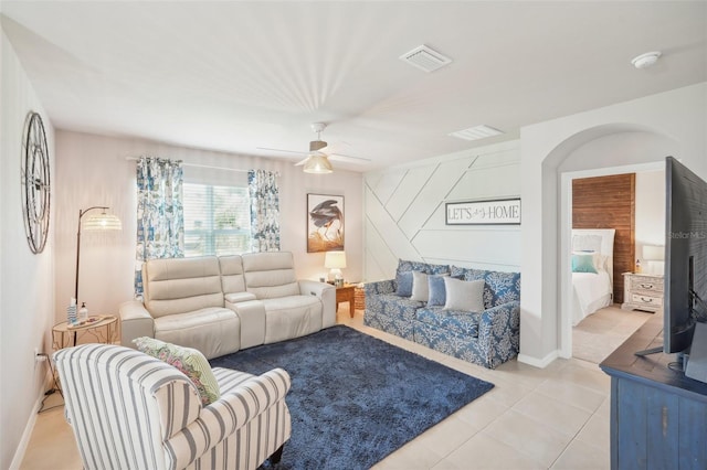 living room featuring a ceiling fan, light tile patterned flooring, and baseboards