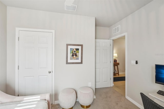 bedroom featuring light carpet and baseboards