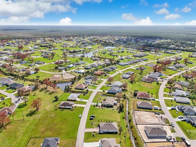 view of property location with nearby suburban area and a large body of water