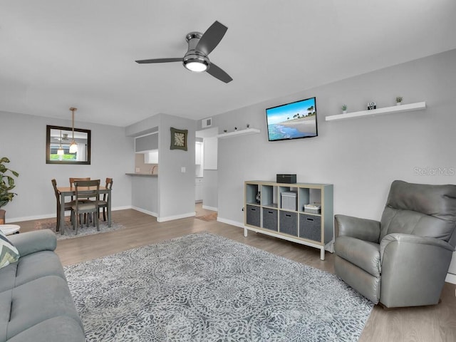 13281 Whitehaven Ln Unit 404, Fort Myers, FL 33966 - living area featuring wood finished floors, ceiling fan, and baseboards