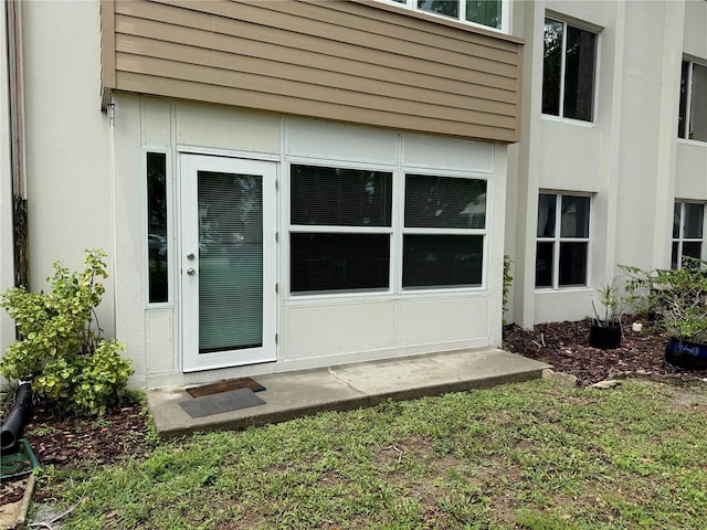 21260 Brinson Ave Unit 110, Port Charlotte, FL 33952 - doorway to property with stucco siding