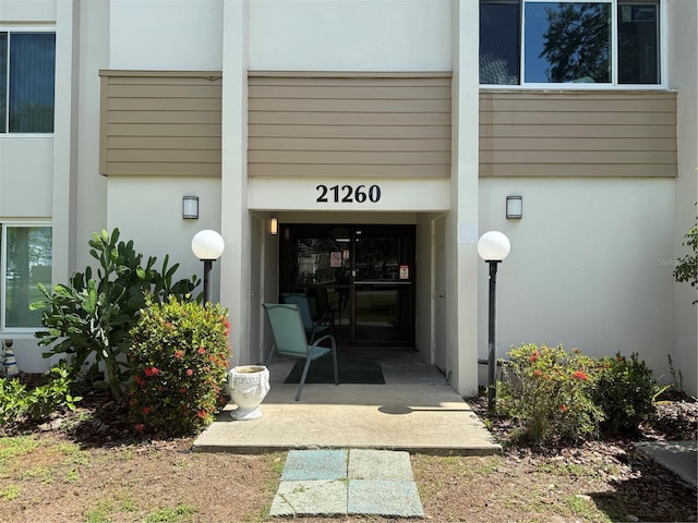 21260 Brinson Ave Unit 110, Port Charlotte, FL 33952 - doorway to property with stucco siding