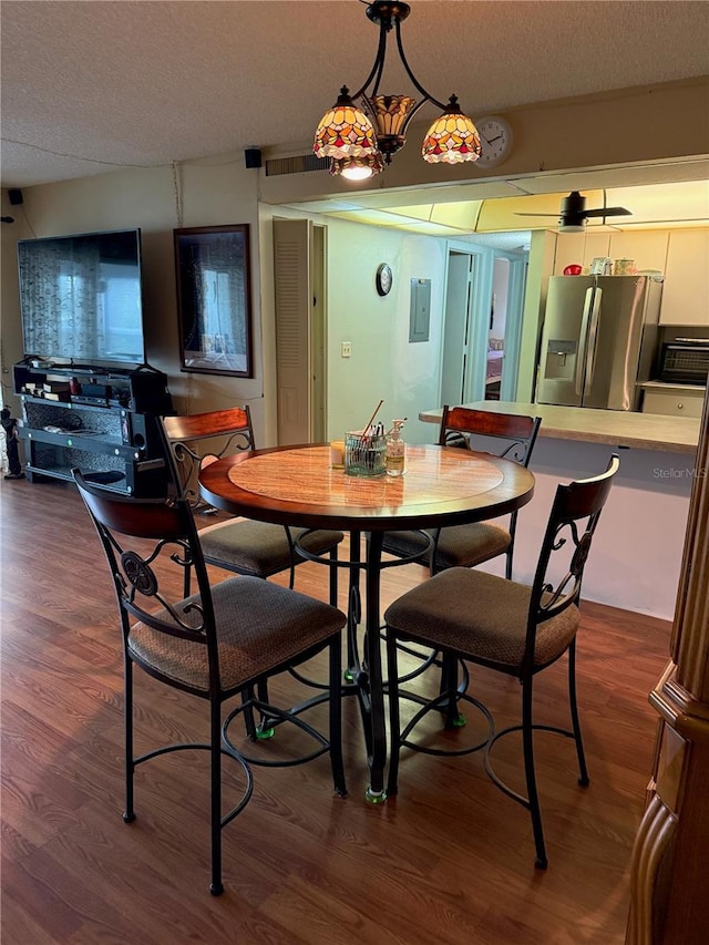 21260 Brinson Ave Unit 110, Port Charlotte, FL 33952 - dining area with electric panel, dark wood-style floors, and a textured ceiling