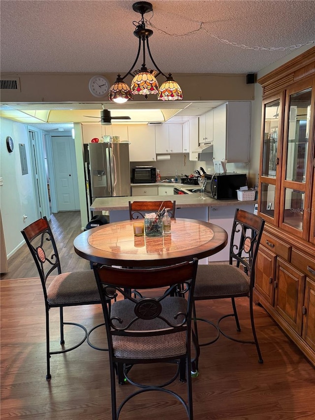 21260 Brinson Ave Unit 110, Port Charlotte, FL 33952 - dining space with wood finished floors and a textured ceiling