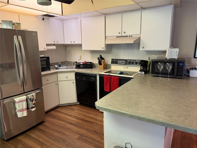 21260 Brinson Ave Unit 110, Port Charlotte, FL 33952 - kitchen with appliances with stainless steel finishes, under cabinet range hood, white cabinetry, and decorative backsplash