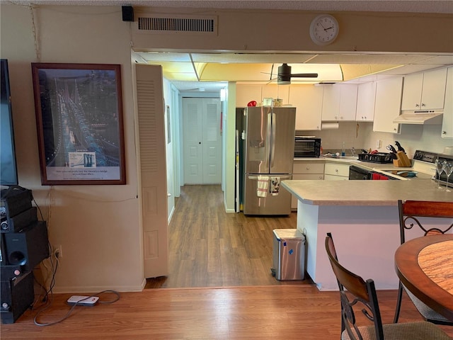 21260 Brinson Ave Unit 110, Port Charlotte, FL 33952 - kitchen featuring stainless steel refrigerator with ice dispenser, range, light wood finished floors, and light countertops