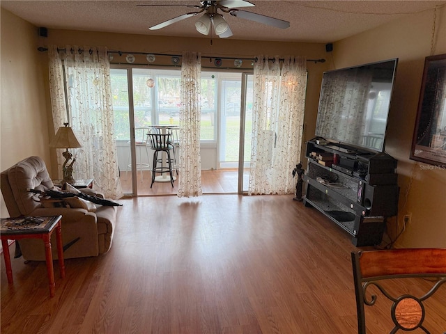 21260 Brinson Ave Unit 110, Port Charlotte, FL 33952 - sitting room featuring ceiling fan, wood finished floors, and a textured ceiling