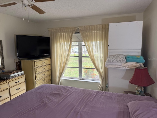 21260 Brinson Ave Unit 110, Port Charlotte, FL 33952 - bedroom featuring a textured ceiling and a ceiling fan