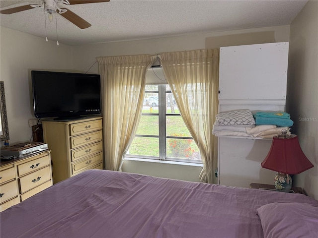 21260 Brinson Ave Unit 110, Port Charlotte, FL 33952 - bedroom with ceiling fan and a textured ceiling