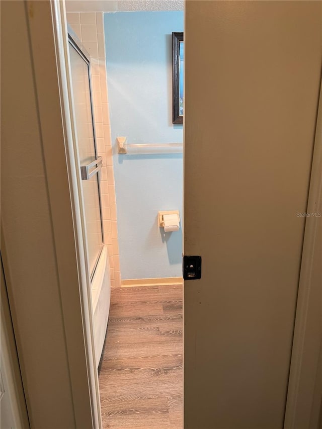 21260 Brinson Ave Unit 110, Port Charlotte, FL 33952 - hallway featuring wood finished floors and baseboards