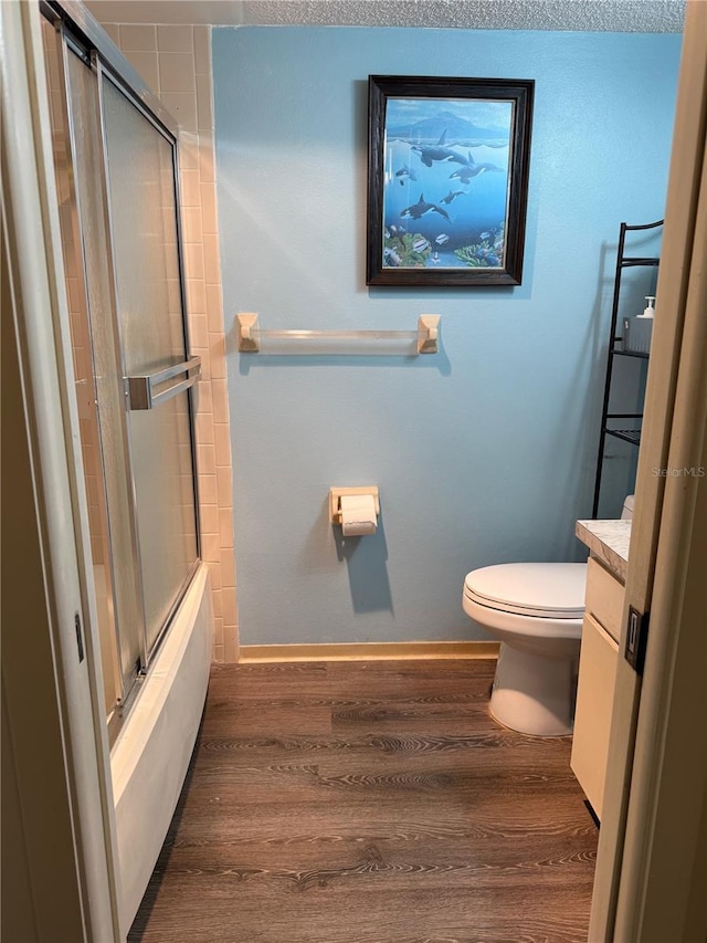 21260 Brinson Ave Unit 110, Port Charlotte, FL 33952 - full bath with wood finished floors, bath / shower combo with glass door, and vanity