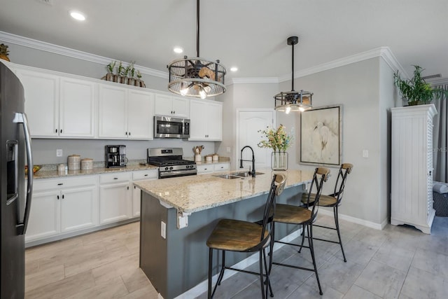 43249 Treadway Dr, Punta Gorda, FL 33982 - kitchen featuring appliances with stainless steel finishes, a sink, ornamental molding, white cabinets, and light stone countertops