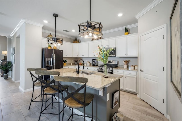 43249 Treadway Dr, Punta Gorda, FL 33982 - kitchen featuring stainless steel appliances, a sink, recessed lighting, ornamental molding, and white cabinetry