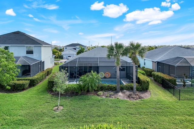 43249 Treadway Dr, Punta Gorda, FL 33982 - back of house with a residential view, glass enclosure, and a yard