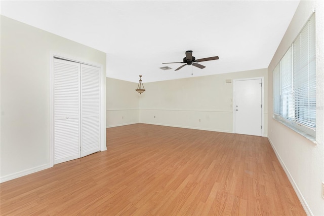 22481 Westchester Blvd Unit B47, Punta Gorda, FL 33980 - unfurnished living room featuring a ceiling fan, light wood finished floors, and baseboards