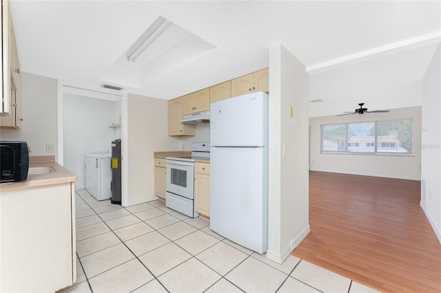 22481 Westchester Blvd Unit B47, Punta Gorda, FL 33980 - kitchen with white appliances, under cabinet range hood, separate washer and dryer, light countertops, and light tile patterned floors