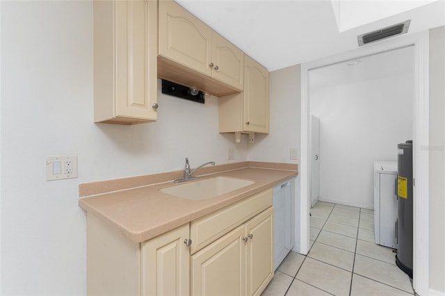 22481 Westchester Blvd Unit B47, Punta Gorda, FL 33980 - kitchen with a sink, cream cabinetry, white dishwasher, light tile patterned flooring, and light countertops
