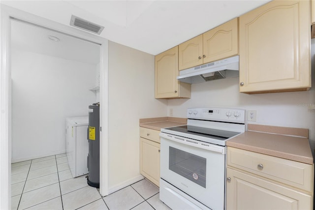 22481 Westchester Blvd Unit B47, Punta Gorda, FL 33980 - kitchen featuring electric range, under cabinet range hood, independent washer and dryer, and light tile patterned floors
