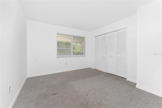 22481 Westchester Blvd Unit B47, Punta Gorda, FL 33980 - unfurnished bedroom featuring carpet, a closet, and baseboards