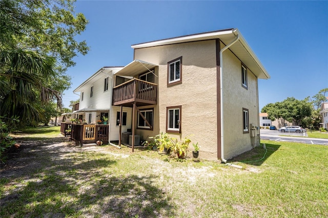 22481 Westchester Blvd Unit B47, Punta Gorda, FL 33980 - back of property with a balcony, stucco siding, a yard, and central AC