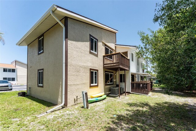 22481 Westchester Blvd Unit B47, Punta Gorda, FL 33980 - back of property featuring stucco siding, a lawn, central AC, and a balcony