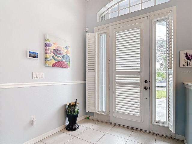 1007 Comstock St, Port Charlotte, FL 33952 - foyer entrance featuring healthy amount of natural light, light tile patterned flooring, and baseboards