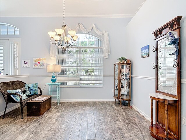 1007 Comstock St, Port Charlotte, FL 33952 - sitting room featuring a chandelier, wood finished floors, crown molding, and healthy amount of natural light