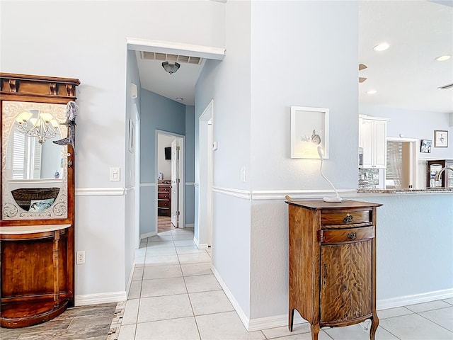 1007 Comstock St, Port Charlotte, FL 33952 - hallway with light tile patterned floors, recessed lighting, and baseboards