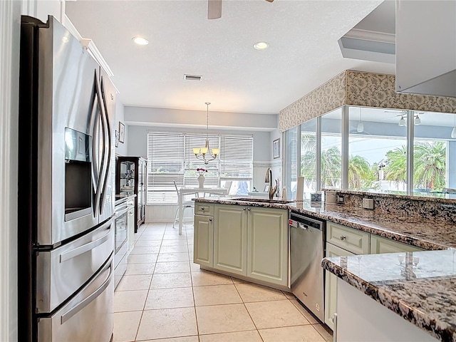 1007 Comstock St, Port Charlotte, FL 33952 - kitchen with stainless steel appliances, a sink, healthy amount of natural light, light tile patterned floors, and recessed lighting