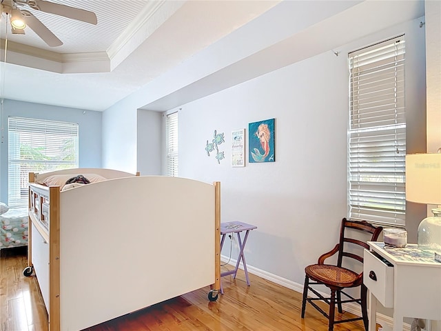 1007 Comstock St, Port Charlotte, FL 33952 - sitting room featuring light wood-type flooring, crown molding, a ceiling fan, a raised ceiling, and baseboards