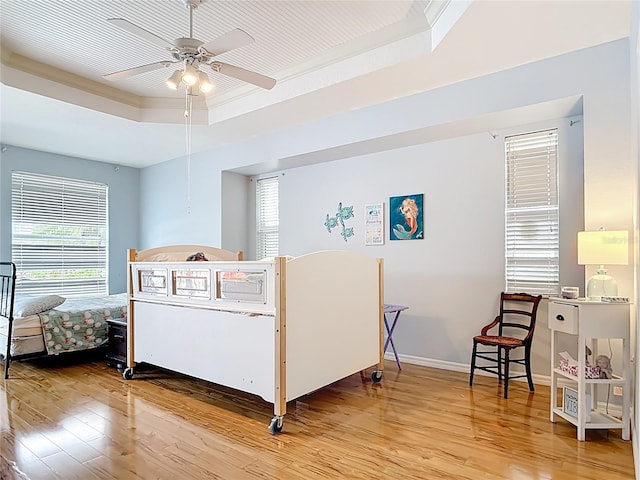 1007 Comstock St, Port Charlotte, FL 33952 - bedroom featuring a tray ceiling, light wood finished floors, crown molding, and baseboards