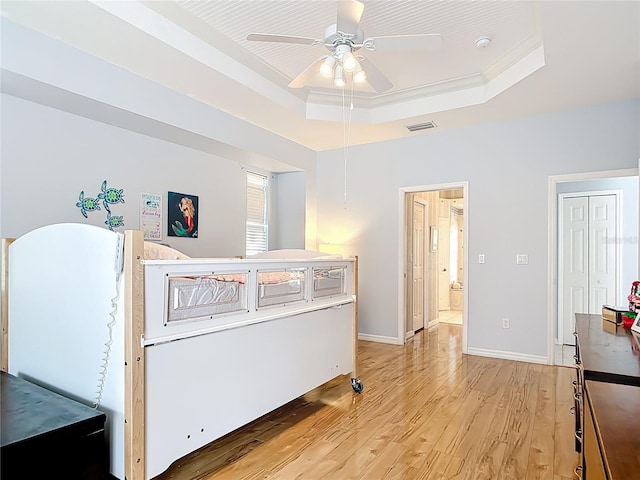 1007 Comstock St, Port Charlotte, FL 33952 - bedroom featuring a raised ceiling, light wood-type flooring, baseboards, and ceiling fan
