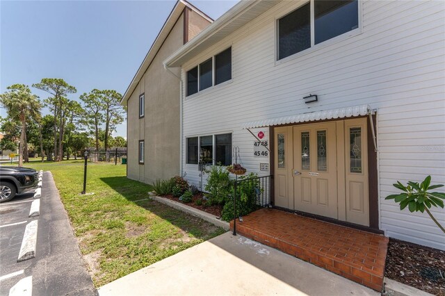22481 Westchester Blvd Unit B48, Punta Gorda, FL 33980 - property entrance with a yard