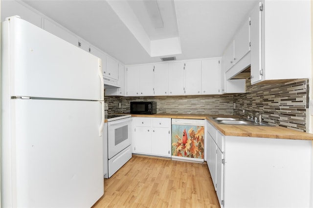 22481 Westchester Blvd Unit B48, Punta Gorda, FL 33980 - kitchen with white appliances, a sink, tasteful backsplash, light wood-style flooring, and white cabinets