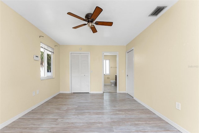 22481 Westchester Blvd Unit B48, Punta Gorda, FL 33980 - unfurnished bedroom with light wood finished floors, baseboards, and ensuite bath