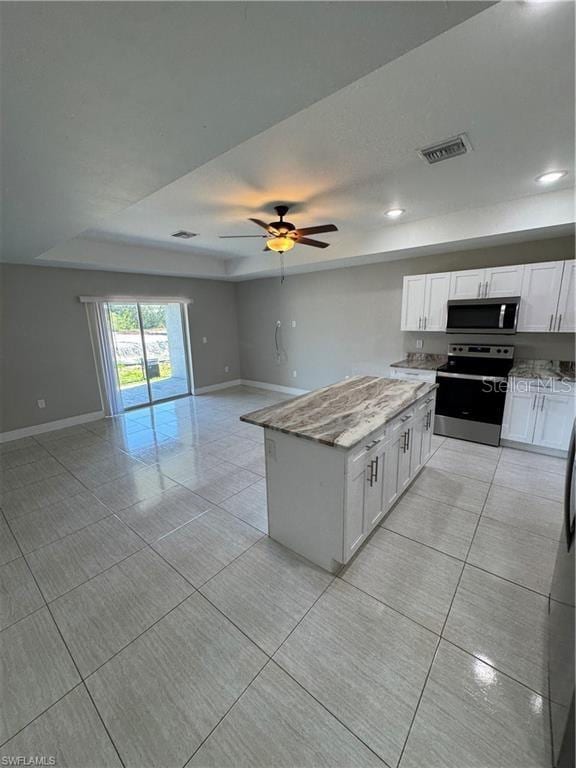 4916/4918 24th St SW, Lehigh Acres, FL 33973 - kitchen with appliances with stainless steel finishes, open floor plan, light stone countertops, baseboards, and recessed lighting
