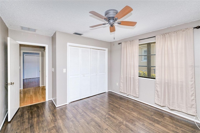 2160 Aqui Esta Dr, Punta Gorda, FL 33950 - unfurnished bedroom featuring wood finished floors, a closet, a textured ceiling, ceiling fan, and baseboards