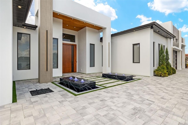 1108 SW 24th St, Cape Coral, FL 33991 - rear view of property with stucco siding, a patio area, and a fire pit