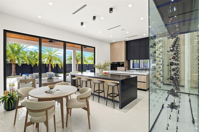 1108 SW 24th St, Cape Coral, FL 33991 - kitchen featuring modern cabinets, recessed lighting, a center island, a kitchen breakfast bar, and light tile patterned floors