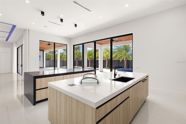 1108 SW 24th St, Cape Coral, FL 33991 - kitchen featuring modern cabinets, a sink, an island with sink, light brown cabinets, and recessed lighting