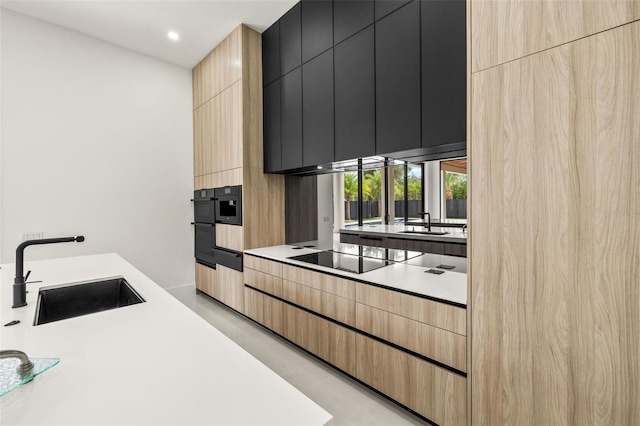 1108 SW 24th St, Cape Coral, FL 33991 - kitchen featuring black electric cooktop, a sink, modern cabinets, light brown cabinetry, and recessed lighting