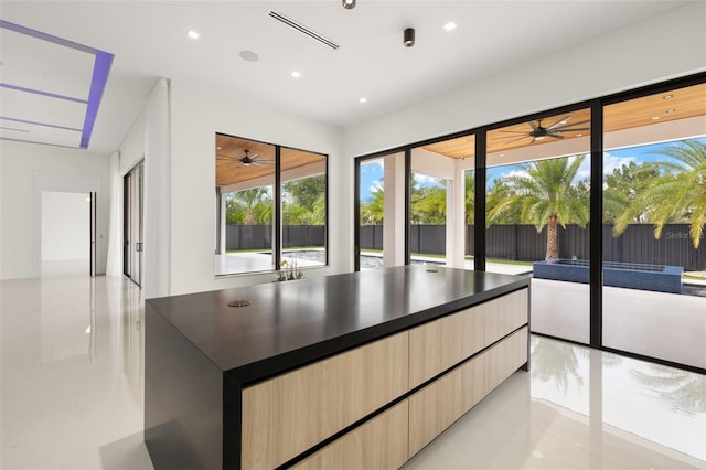 1108 SW 24th St, Cape Coral, FL 33991 - kitchen with modern cabinets, ceiling fan, light brown cabinets, dark countertops, and light tile patterned floors