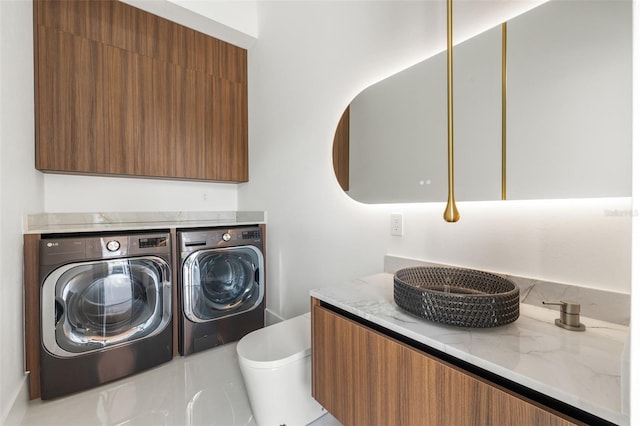 1108 SW 24th St, Cape Coral, FL 33991 - laundry room featuring washing machine and clothes dryer and cabinet space