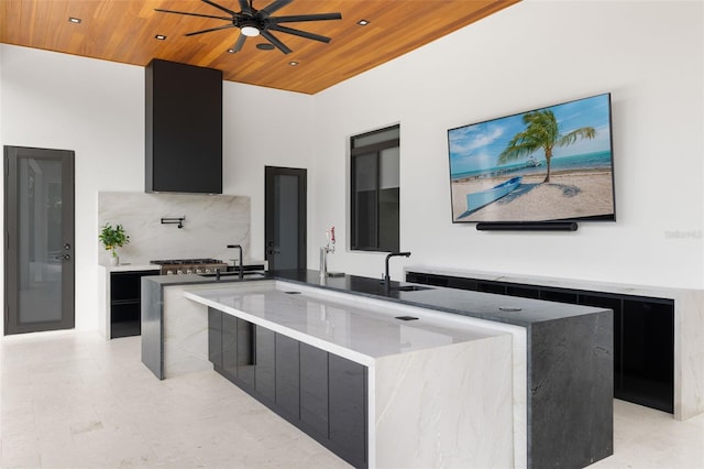 1108 SW 24th St, Cape Coral, FL 33991 - kitchen with dark cabinets, modern cabinets, wooden ceiling, a ceiling fan, and a center island with sink