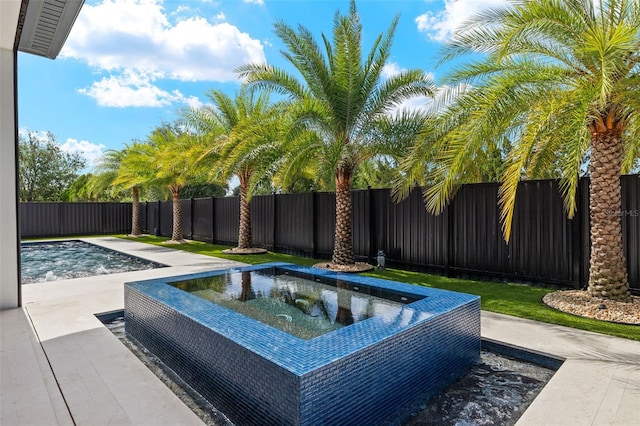 1108 SW 24th St, Cape Coral, FL 33991 - view of swimming pool with an outdoor hot tub and a fenced backyard