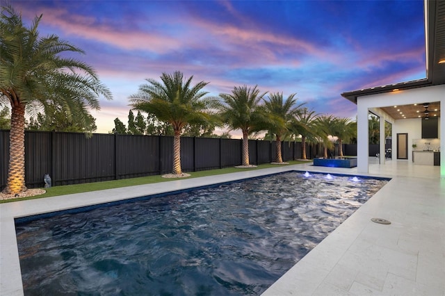 1108 SW 24th St, Cape Coral, FL 33991 - pool at dusk with a fenced backyard and a patio area
